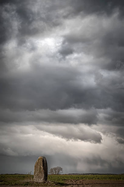 istock Single standing stone in the Swedish countryside against a dramatic cloudy sky 1454571535
