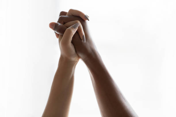 istock Multiracial black and white hands holding each other 1454574637