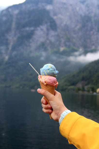 istock multi-colored ice cream in a horn in a hand 1454578230