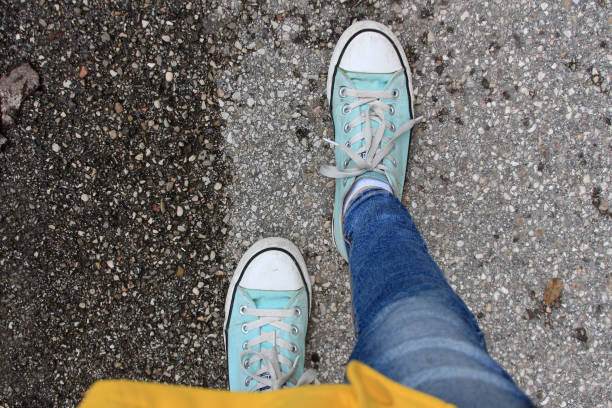 istock legs in blue sneakers are on the road 1454578272