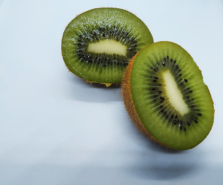 slice of ripe green kiwi isolated in white background ,close up view