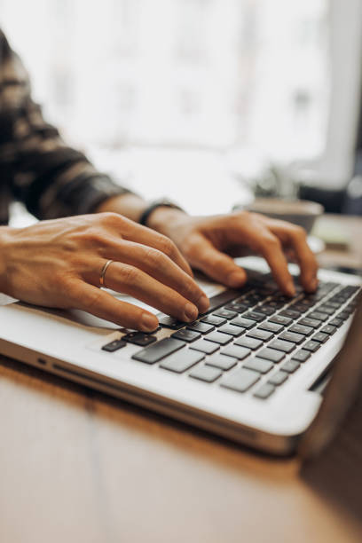 istock Hands of digital nomad browsing netbook in coffee shop 1454578416