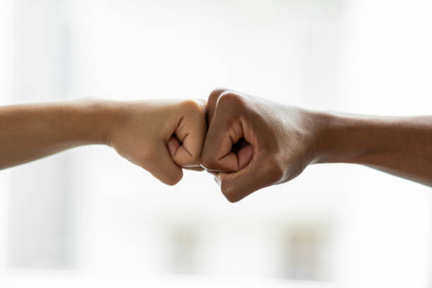 istock Hands giving a fist bump in agreement partnership 1454579308