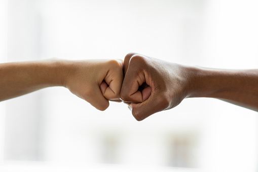 Hands giving a fist bump in agreement partnership