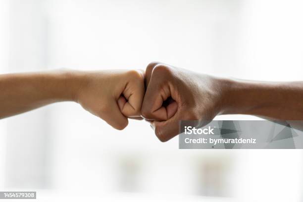 Hands Giving A Fist Bump In Agreement Partnership Stock Photo - Download Image Now - Reconciliation, Cut Out, Knuckle