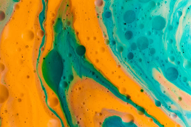 istock Abstract shapes in orange and blue paint mixed with oil 1454579670