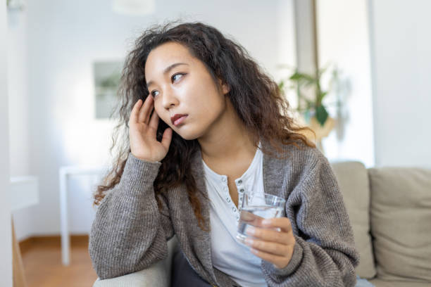istock Sinus ache causing very paintful headache. Unhealthy Asian woman in pain. Sharp strong sore. Sinus pain, sinus pressure, sinusitis. Sad woman holding her head because sinus pain 1454581767