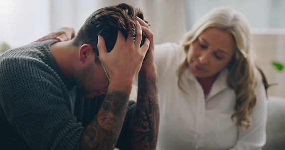 Sad, stress and depression people in therapy for mental health support, empathy and professional help of woman giving advice or listening to problem. Depressed, anxiety and cry man with psychologist