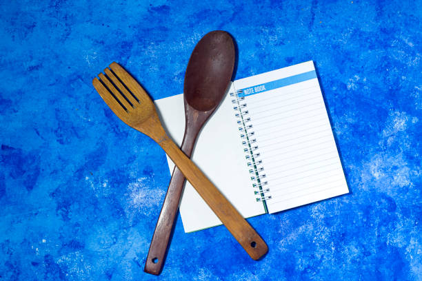 Blank vintage recipe cooking book and utensils. Top view with copy space