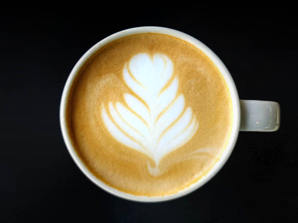 istock A cup of latte art coffee isolate on dark background 1454585019