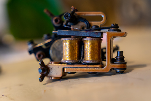 Detail of Antique coffee bean original grinder metal shake wheel with hand crank. Close-up of Old original coffee grinder, Space for text, Selective focus.