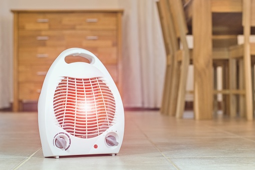 Electric fan heater in the cozy home interior.