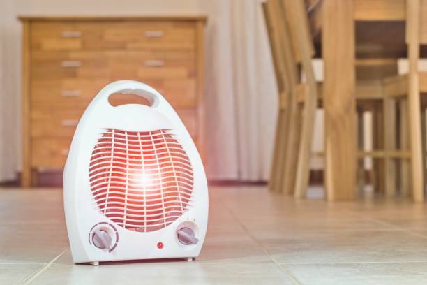 Electric fan heater in the cozy home interior. Electric fan heater in the cozy home interior. radiator stock pictures, royalty-free photos & images