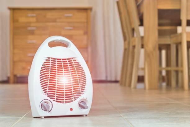 Electric fan heater in the cozy home interior. Electric fan heater in the cozy home interior. electric heater stock pictures, royalty-free photos & images