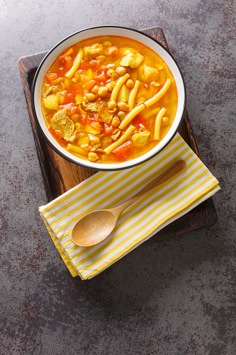 Rancho Canario is a traditional Canarian soup, with a stew-like consistency from the Canary Islands closeup on the plate on the table. Vertical top view from above