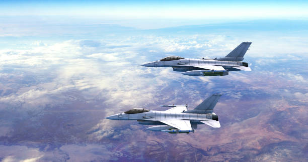 istock Military Fighter Jets Flying Together Over Clouds. Aerial View. 1454592967