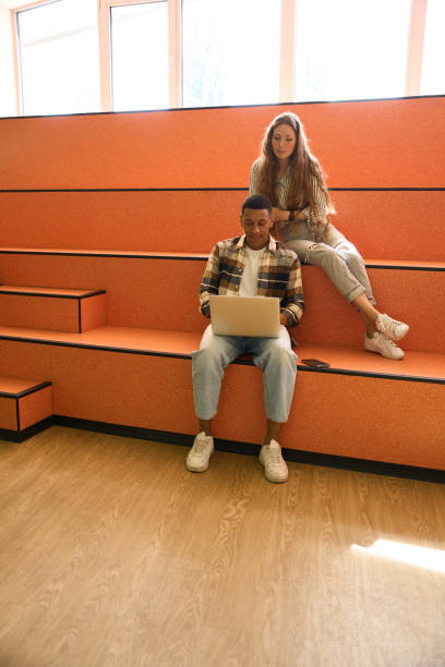 istock Young man and woman looking at laptop screen 1454593630