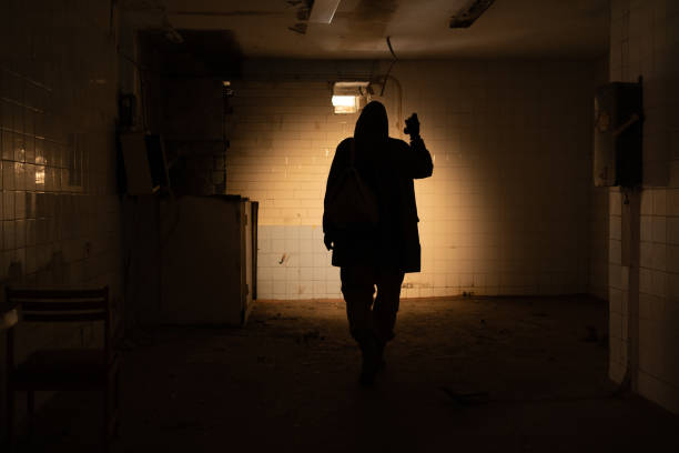 istock Post Apocalypse survivor concept, Ruins Apocalyptic abandoned building, a man with flashlight 1454594546