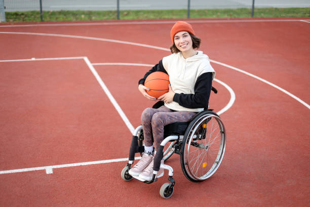 istock Disabled young woman playing basketball 1454595632