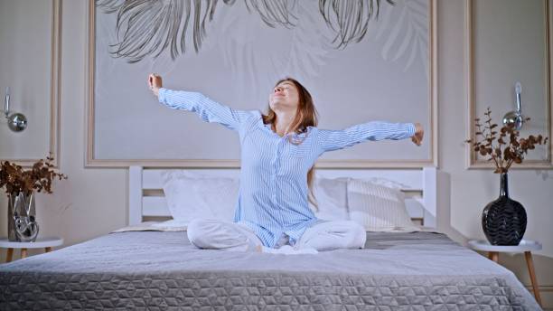 istock Young woman stretching in bedr 1454596791