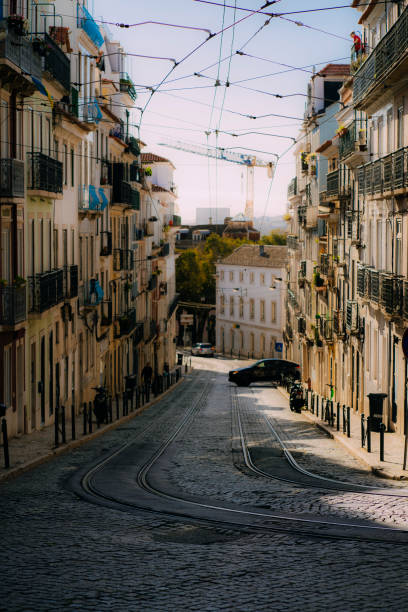 istock Cobblestone street in historical Lisbon with Tram tracks 1454598962