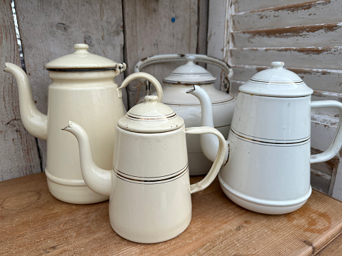 Old vintage porcelain teapot with crack  isolated on the white background.