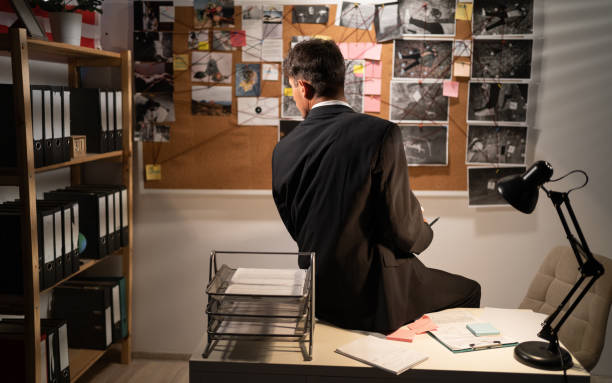 istock Detective looking at investigation board in office, searching for solution, back view 1454605745
