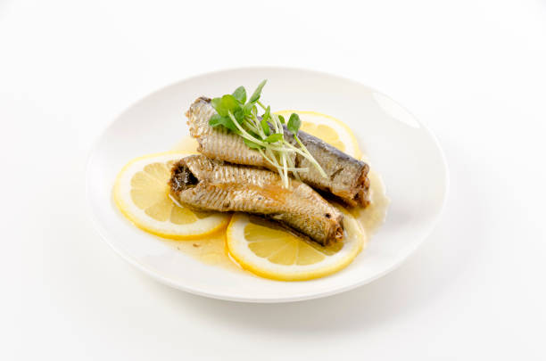 istock Sardines with slice lemon on a white plate 1454610663