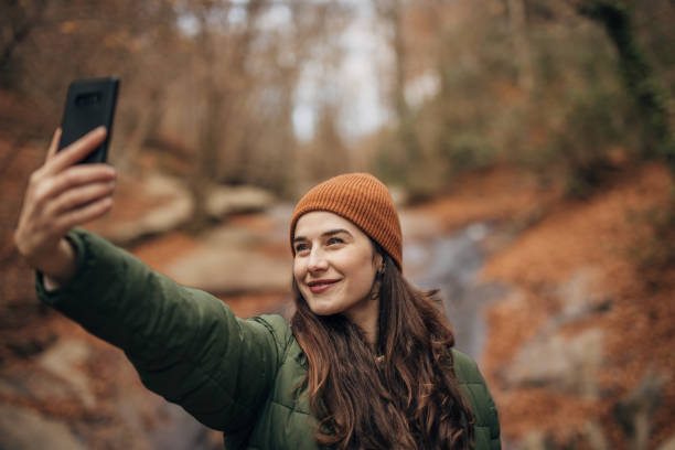istock Woman taking a selfie in nature 1454611845