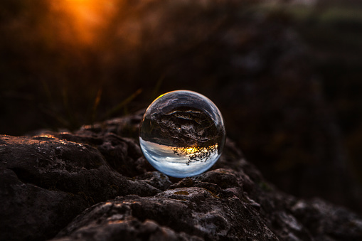 A crystal ball with a view reflected in it