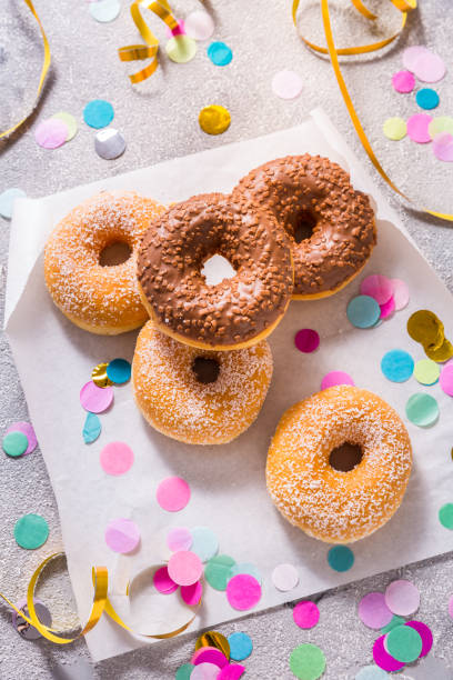 istock Krapfen, berliner or donuts with streamers, confetti  for carnival or party 1454619482