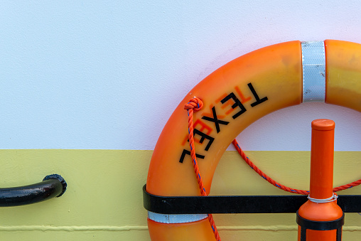 The name of the wadden sea island Texel on a life buoy at a fishing trawler.