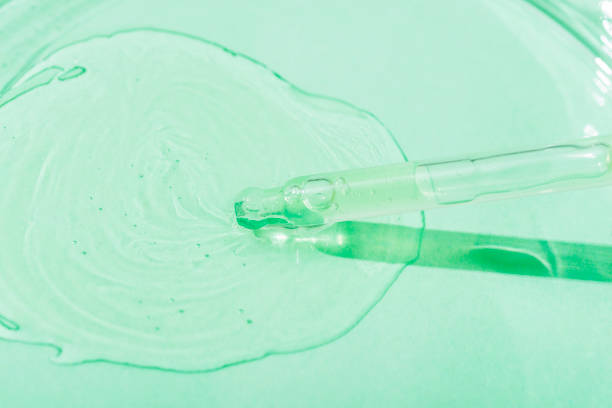 istock Cosmetic pipette serum on a petri dish on light green background with sharp shadow. Cosmetology and pharmaceuticals concept. Acid peeling, collagen, hyaluronic acid 1454622091