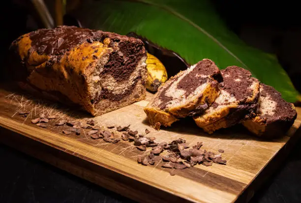 Slices of Banana Bread infused with chocolate on a background of banana leaves