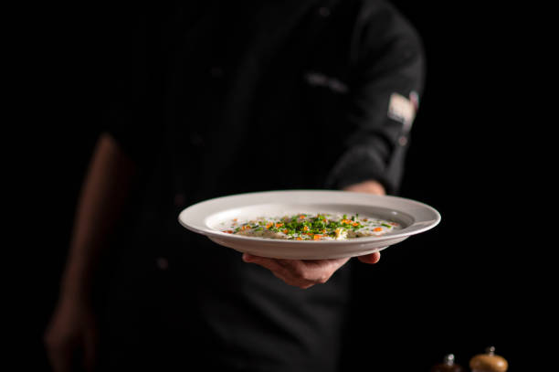 istock A male chef serving a fine dining dish in a restaurant 1454623448
