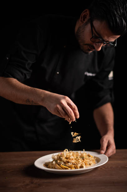 istock A male chef decorating a plate in a restaurant 1454623594
