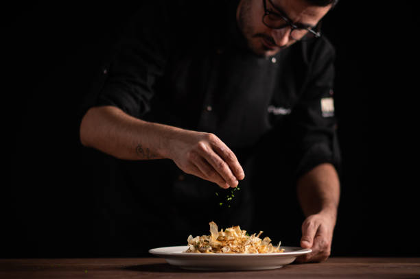 istock A male chef decorating a plate in a restaurant 1454623609