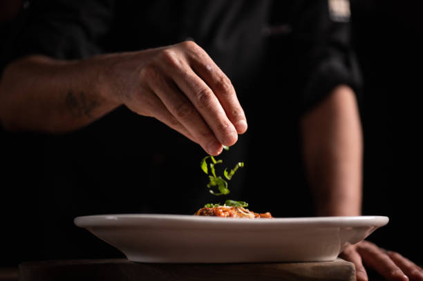 istock A male chef decorating a plate in a restaurant 1454623636