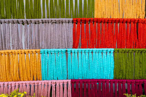 Many of the threads that are dyed brightly are the ones that have been prepared for the traditional loom because the fabric woven on the traditional loom is handmade and expensive.