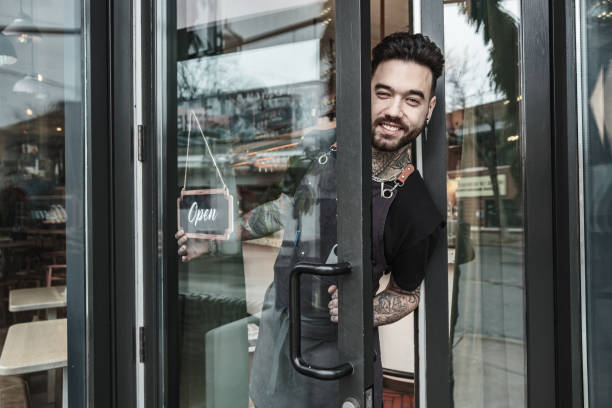 istock Young tattooed barman opening the bar 1454624338