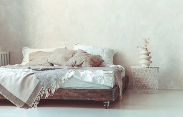 istock Stylish minimalist loft style bedroom interior with bed and metal round bedside table 1454624352