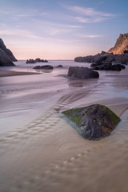 istock curious rock formations in the sea under sunset light 1454624964