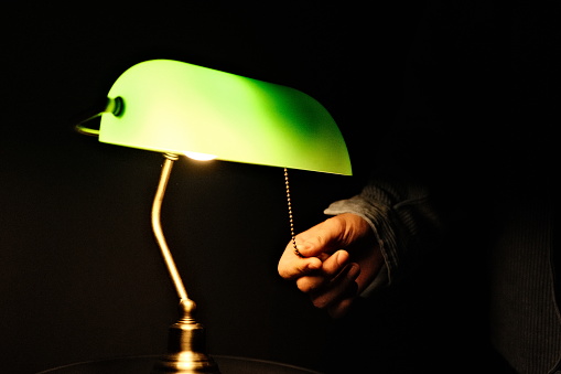 Turning off a green lamp black background