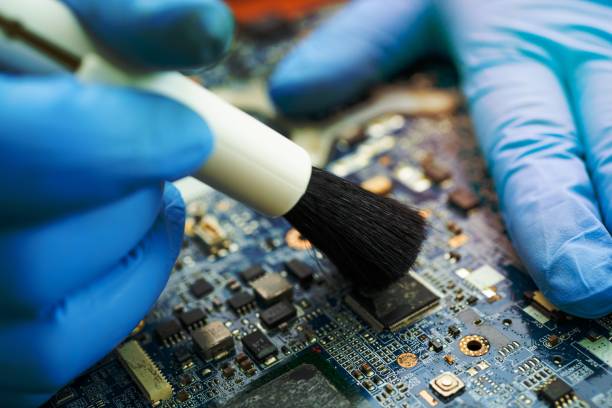 istock Technician use brush and air blower ball to clean dust in circuit board computer. Repair upgrade and maintenance technology. 1454626582