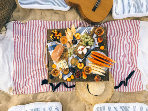 istock Delicious food on table on beach 1454626882
