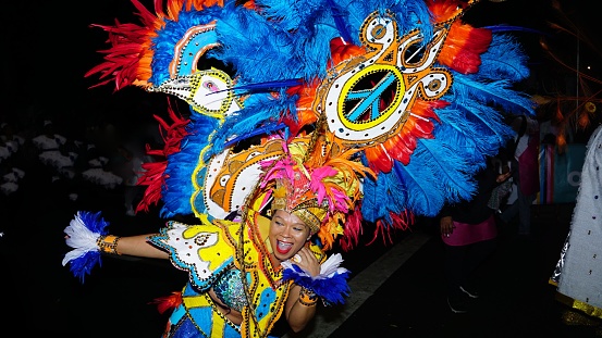 Nassau, Bahamas – December 26, 2022: A woman dancing in a traditional costume during a Junkanoo parade in the Bahamas.