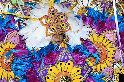 Nassau, Bahamas – December 26, 2022: A woman in a traditional costume during a Junkanoo parade in the Bahamas.