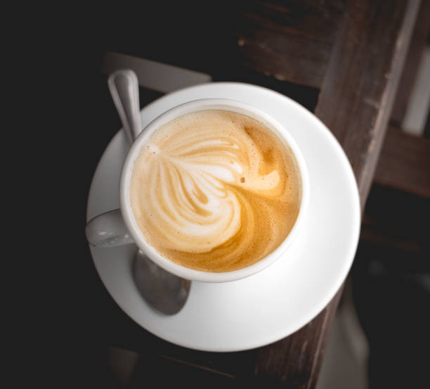 istock High angle shot of coffee in a white coffee cup on a brown table 1454627768