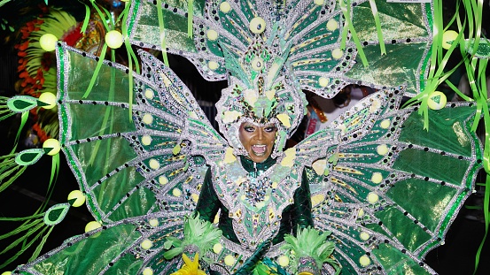Nassau, Bahamas – December 26, 2022: A woman dancing in a traditional costume during a Junkanoo parade in the Bahamas.