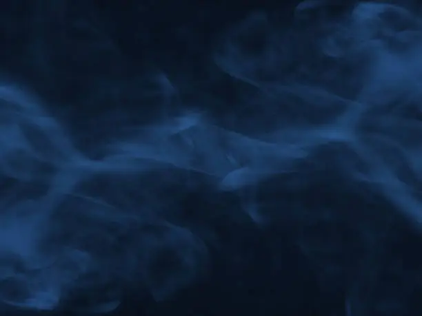 Blue smoke on dark background.